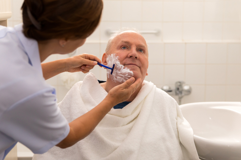 carer shaving resident