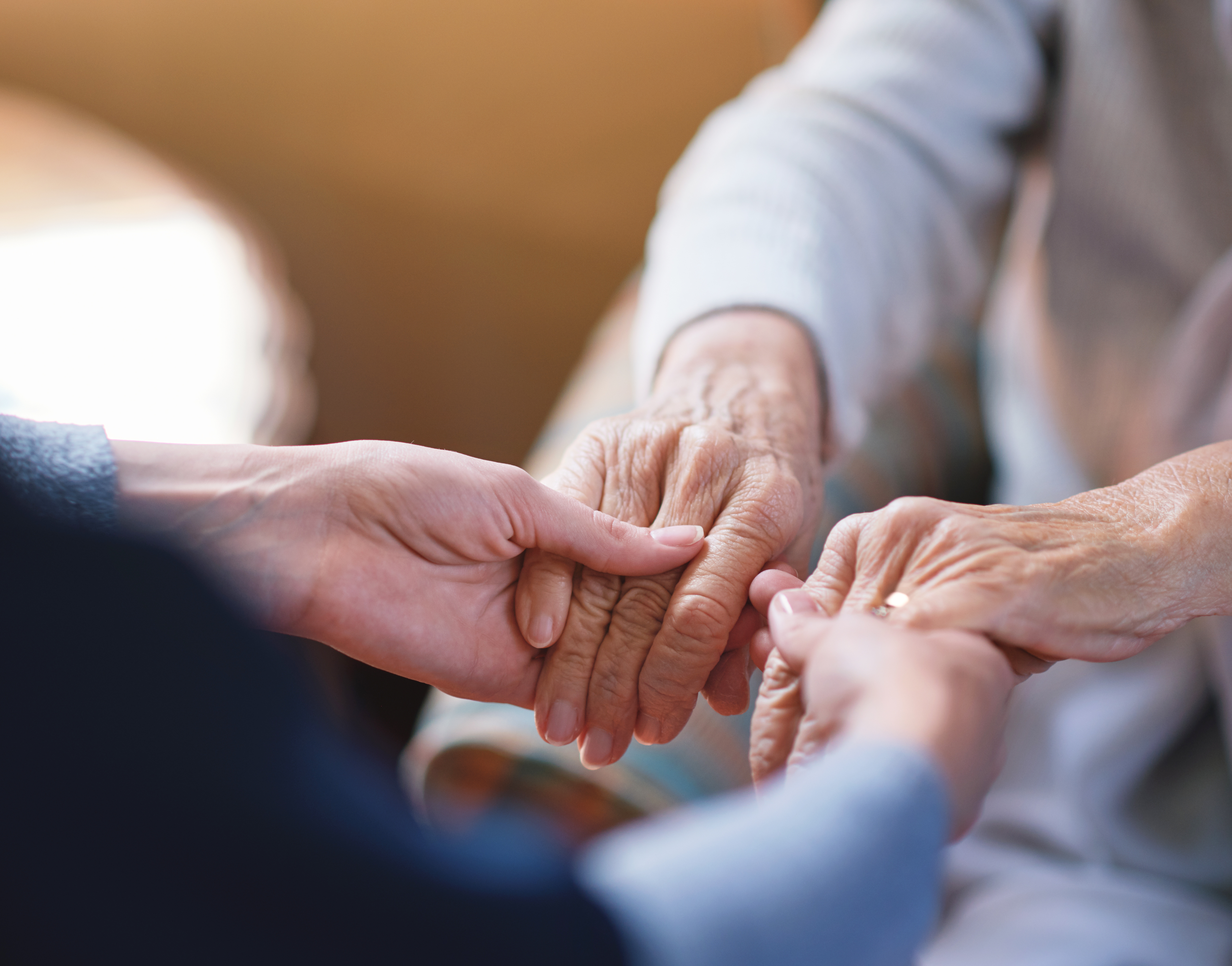 Carer holding hands with a resident