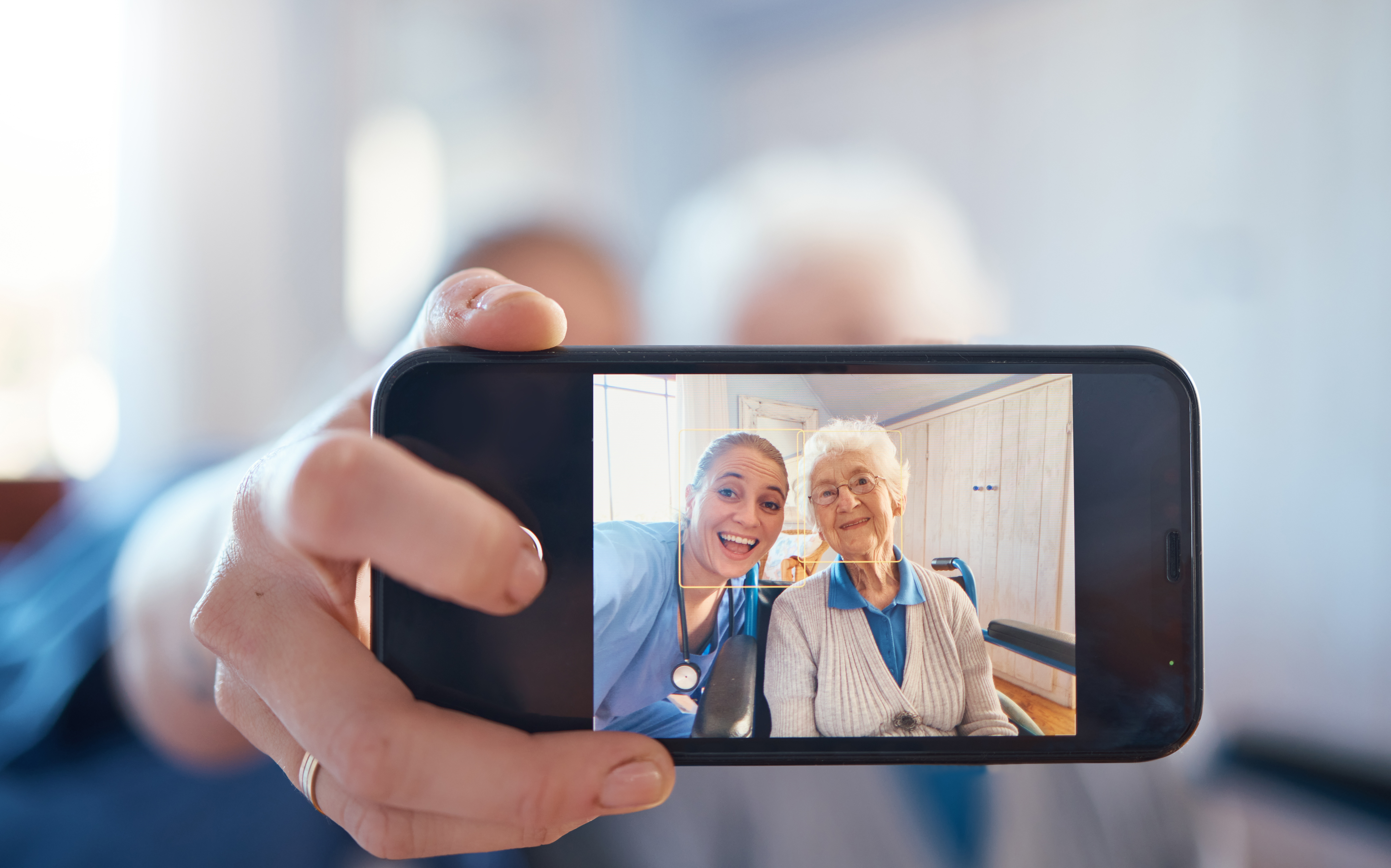 A carer and their resident taking a selfie.